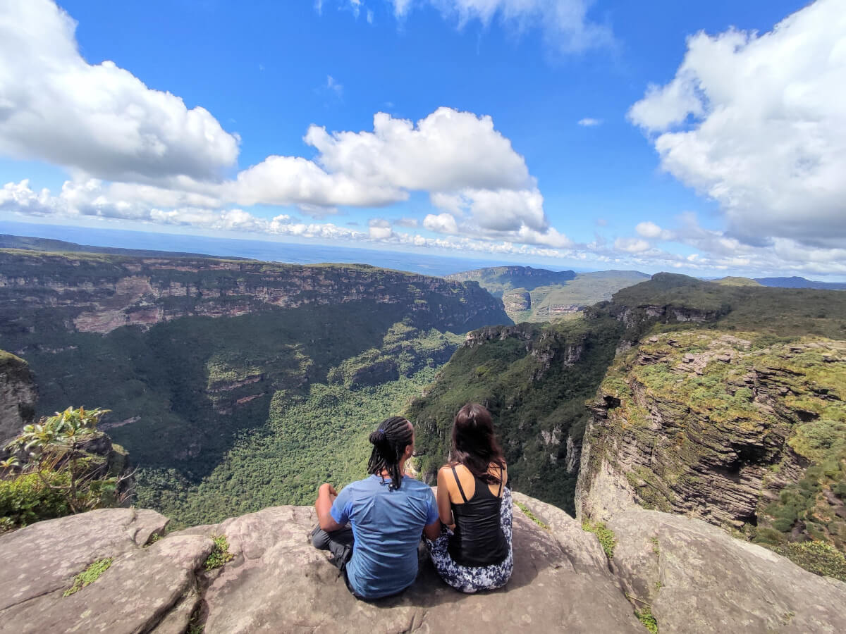 Couple sitting on the top of the fumaca waterfall