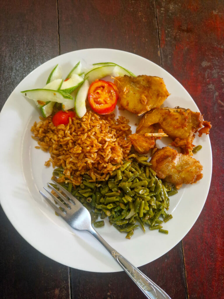 Suriname food: Rice with veggies and fish