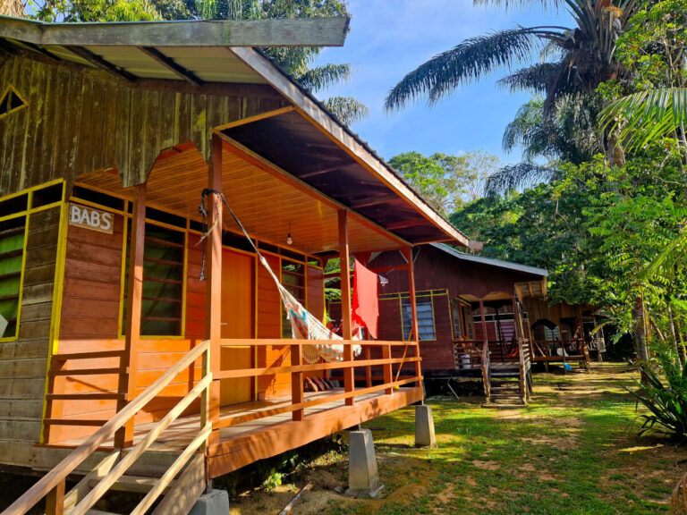 Man chillling on a hammock in the Ping Pe resort, Suriname