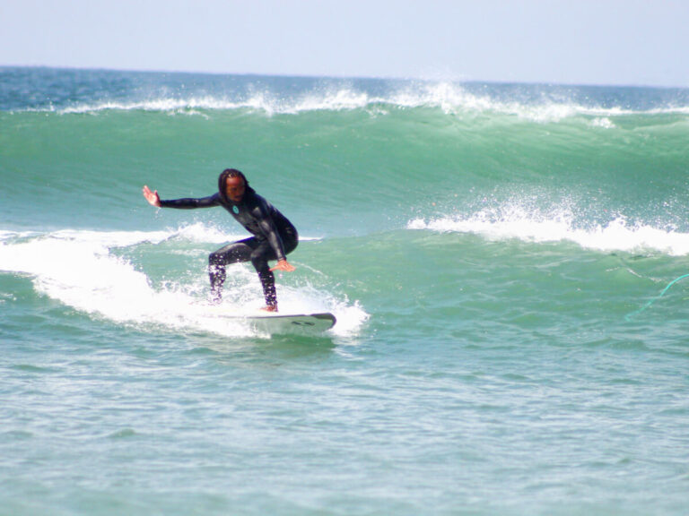 Man surfing in Playa Punta in Lobitos, Peru