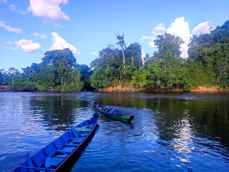 People on a boat in the Marooms Villages in Suriname