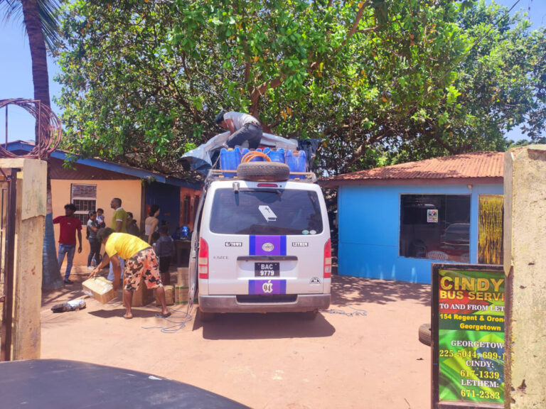 People unpacking van in Lethem, Guyana