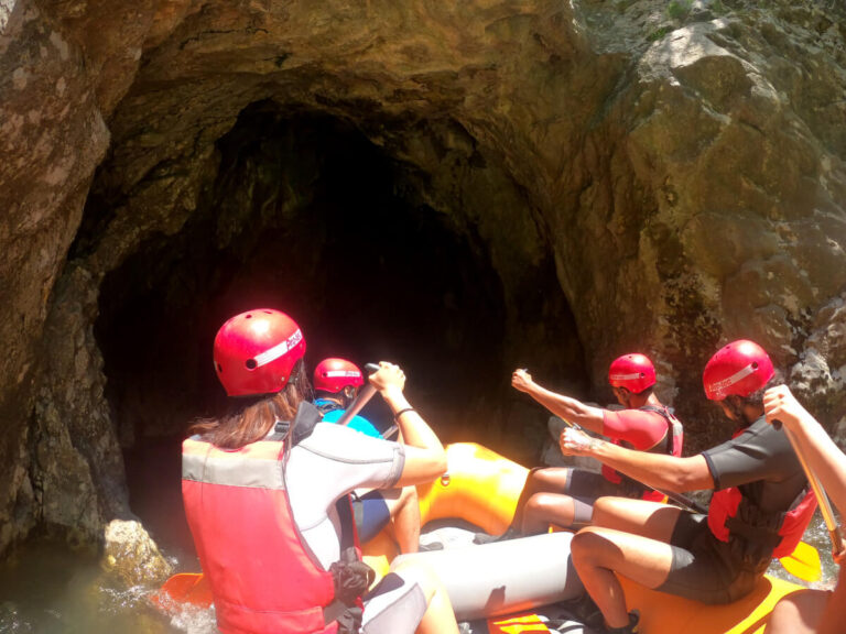 People entering a cave at the Lim River while rafting in Serbia