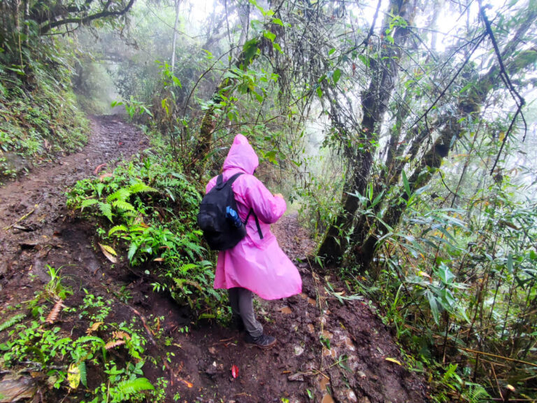 Girl hiking on the muddy trail in Llactapata, Peru