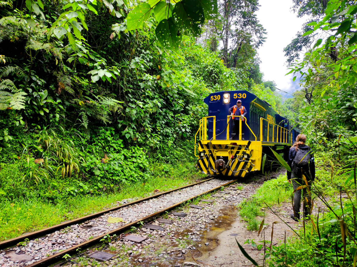 Girl waiting for the train to pass in Hidroeletrica, Peru