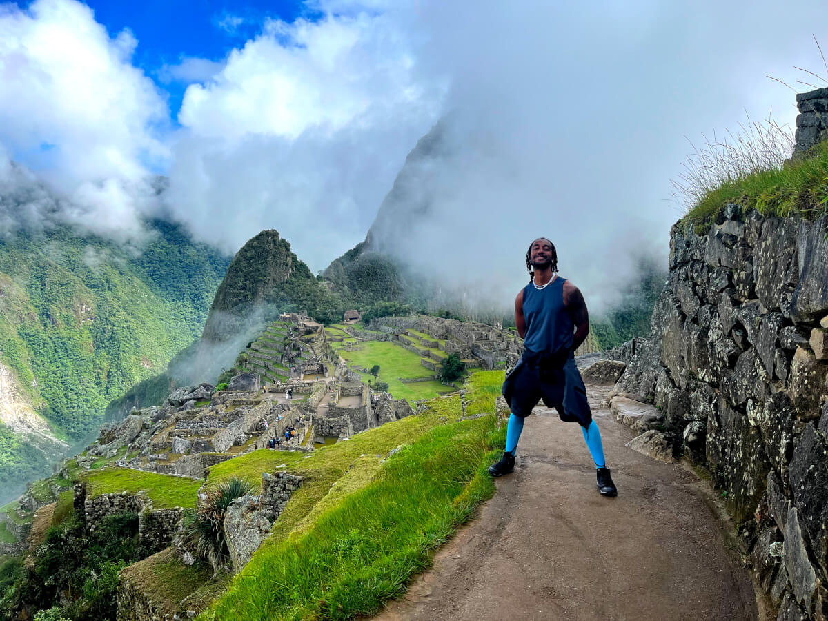 Man at the Machu Picchu archaeological site after doing the Salkantay Trek