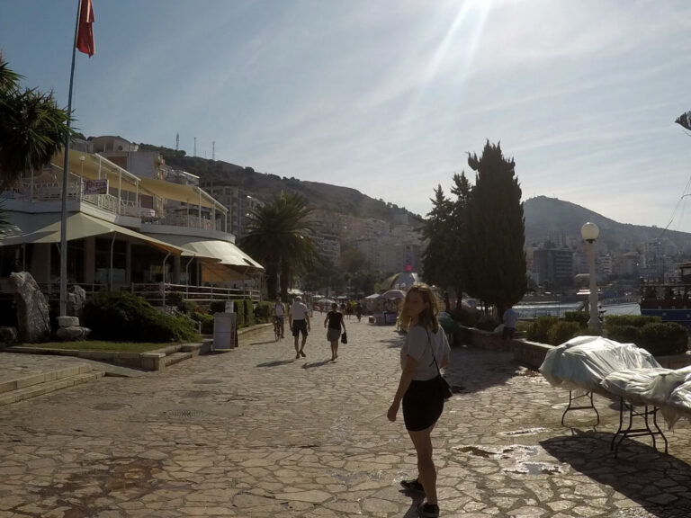 Woman walking on a promenade in Sarande, Albania