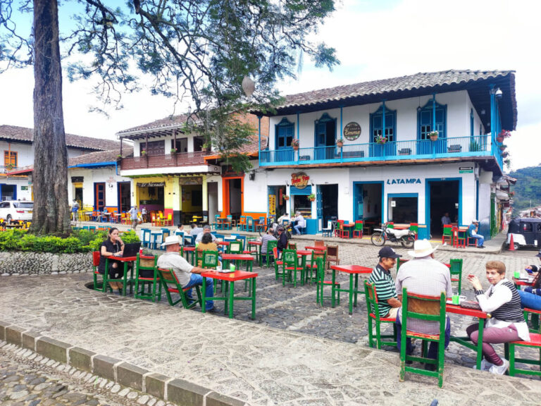 Locals drinking coffee in the central plaza in Jardin, part of the Colombia travel itinerary for three weeks